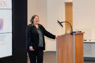 Vitulli stands at lecture