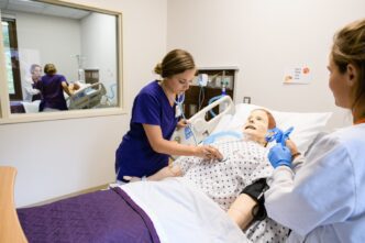 Nursing students practice running scenarios in the newly renovated simulation space in Edwards Hall.