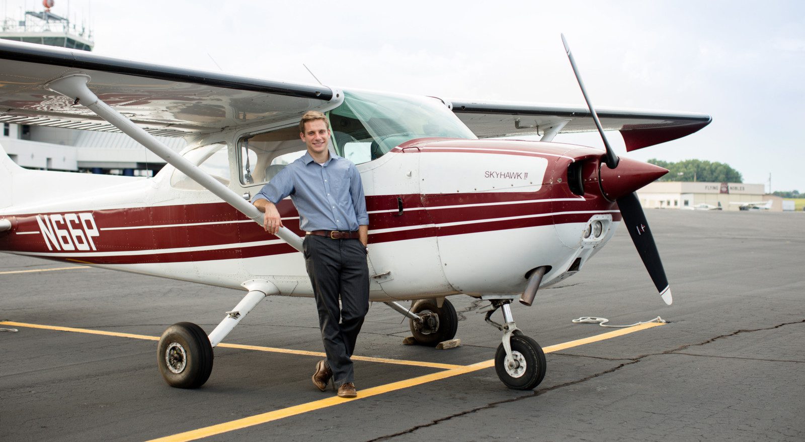 Corey Benson next to airplane
