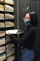 woman filing wearing a mask