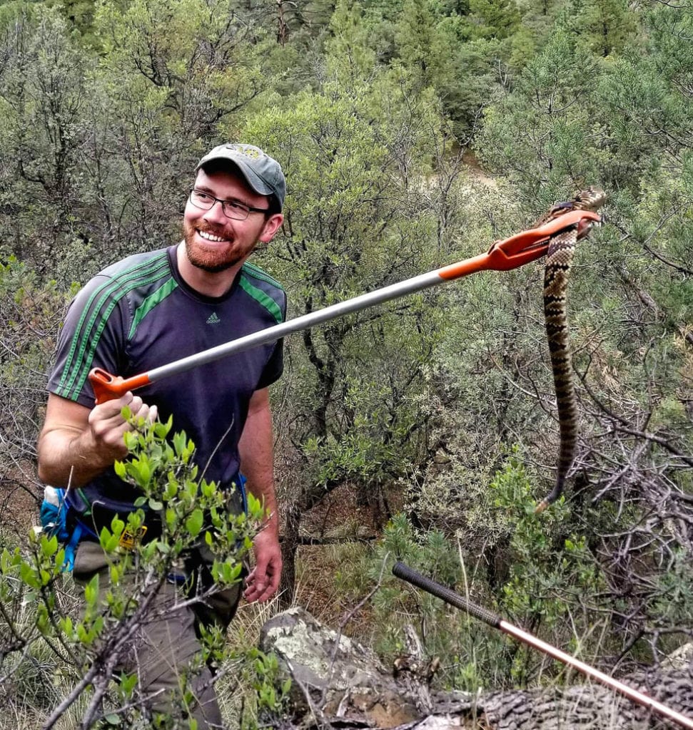 Matthew Holding holding a rattlesnake