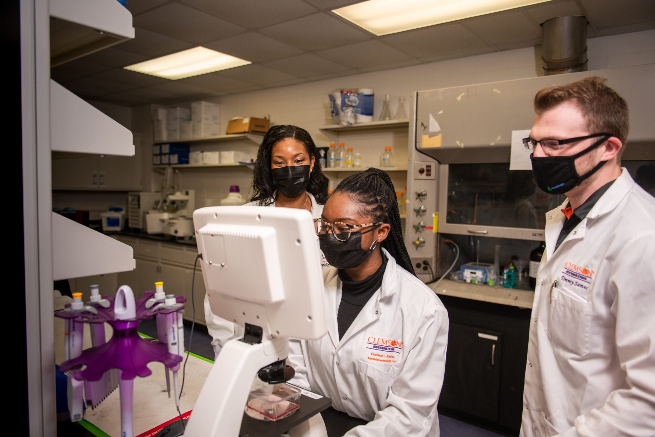 Angela Alexander-Bryant (left) works in her lab with Kharimat Lora Alatise (center) and Timmy Samec.