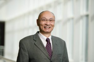 Headshot of Chenning Tong in a bright hallway.