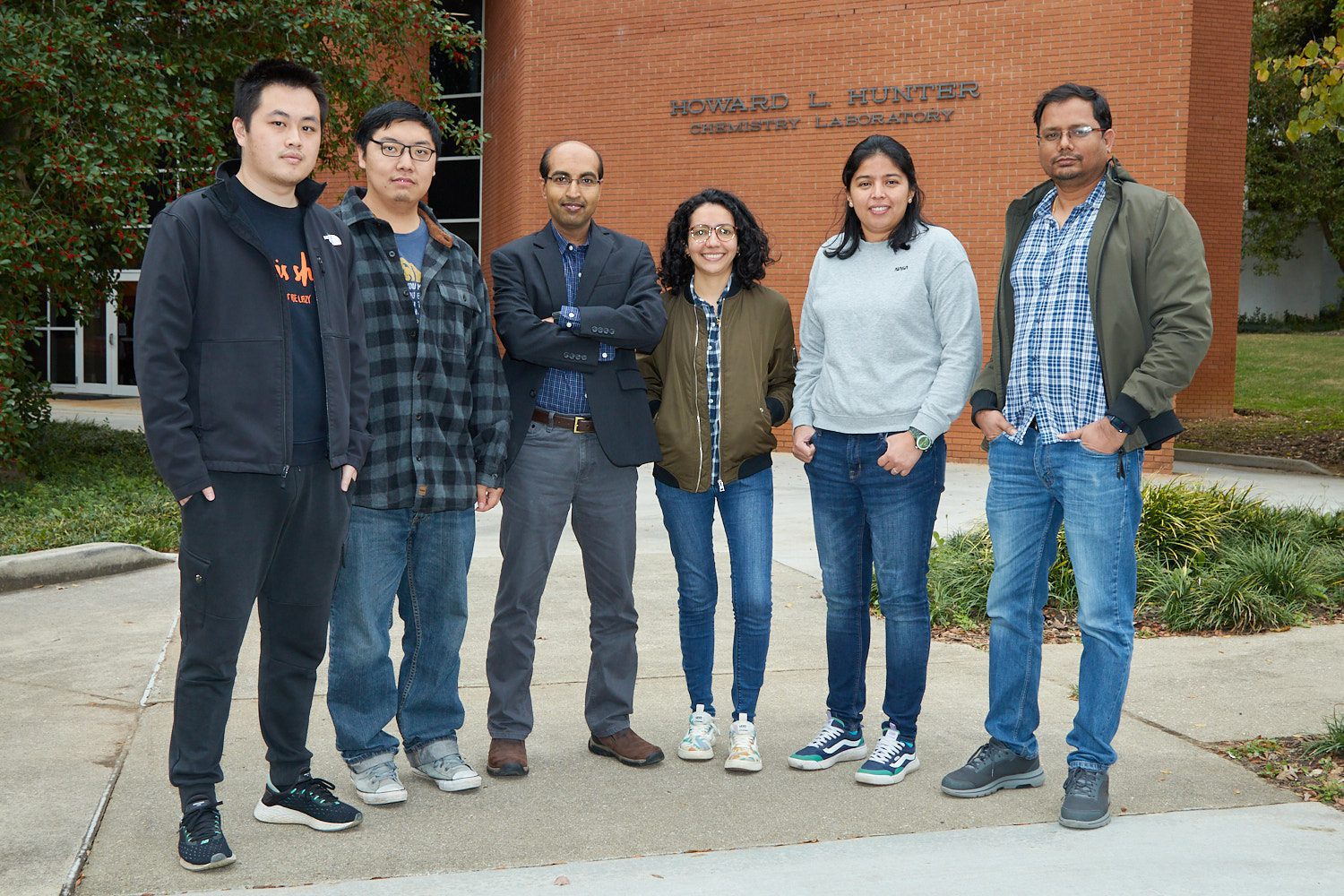 Six people standing in front of Hunter Hall on Clemson University's campus