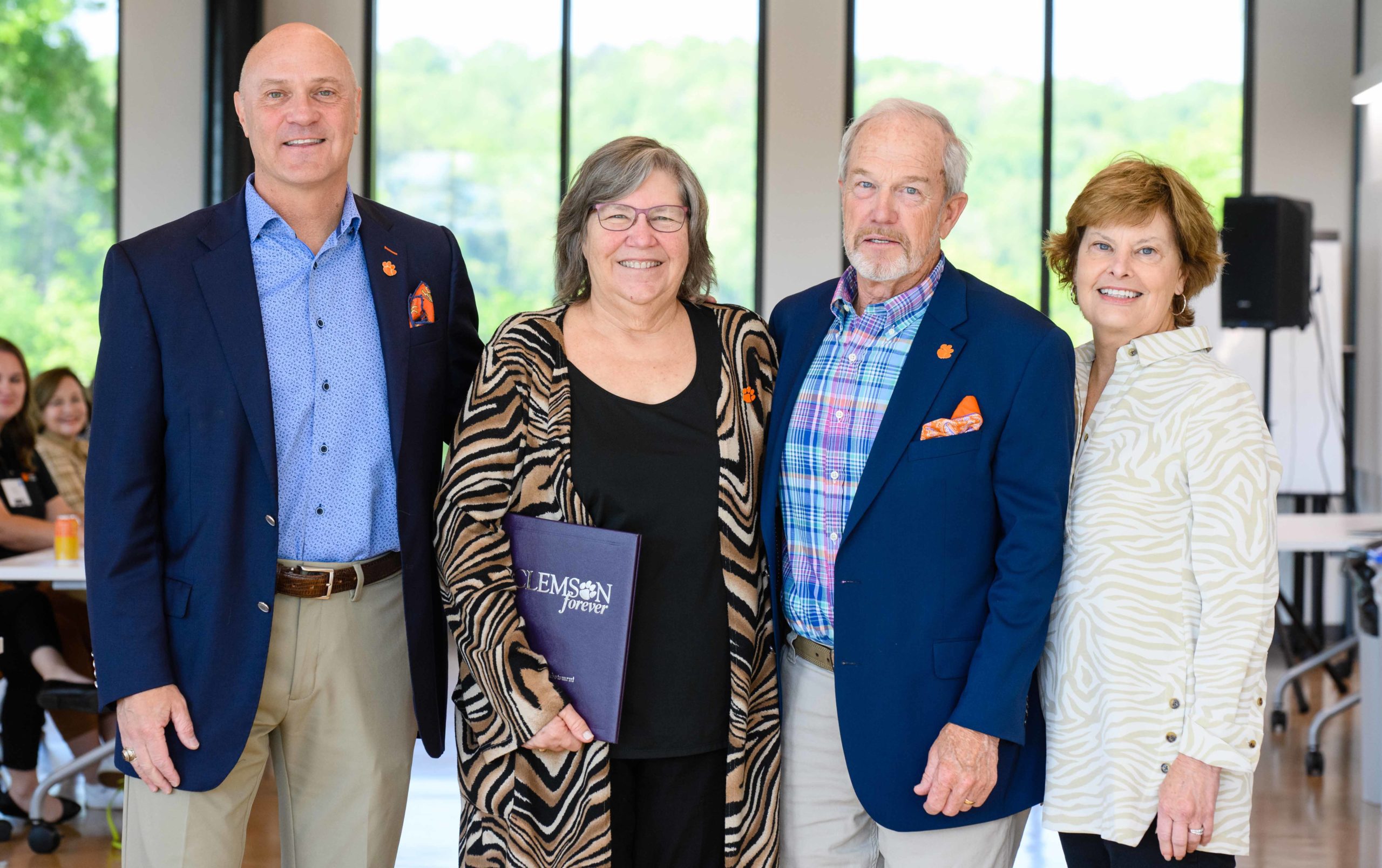 Jim Clements stands next to Patricia Layton who stands next to Micky and Amy Scott. Pat is being honored with a directorship in her name.