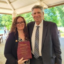 2022 Frank A. Burtner award recipient Robyn Curtis posing with her award and Stephen Wainscott, former director of the Clemson University Honors College.