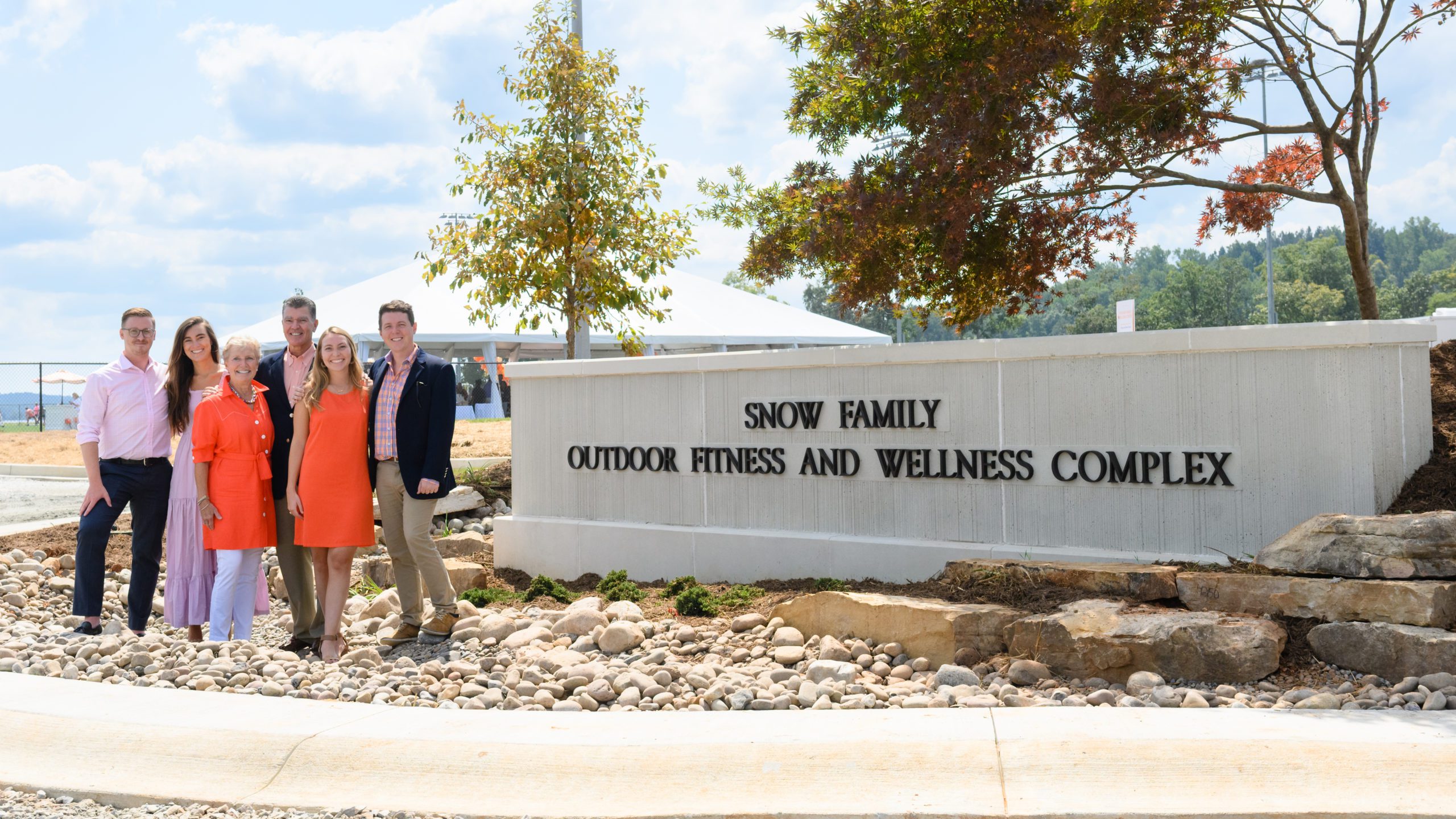 Dave and Lynette Snow with their family at the entrance to the complex bearing their name