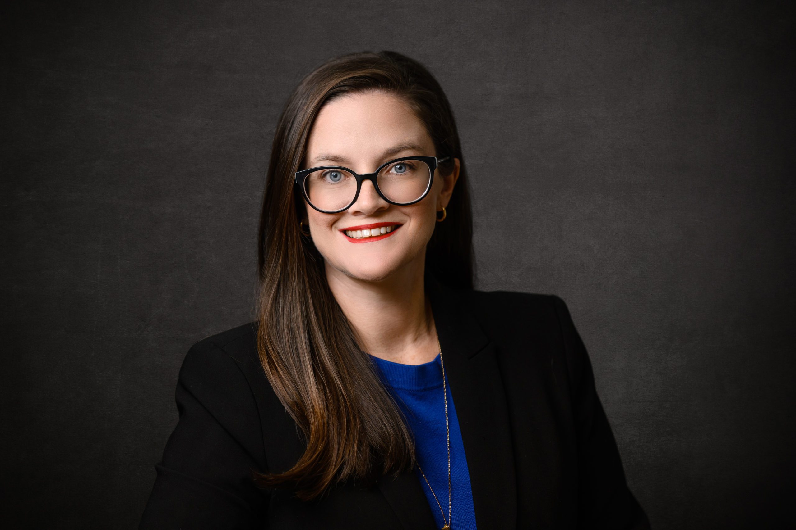 A headshot of April Purvis, chief operating officer of the Clemson University Foundation, with a black background.