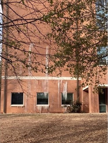 Icicles hang off the side of building during freezing cold of Winter