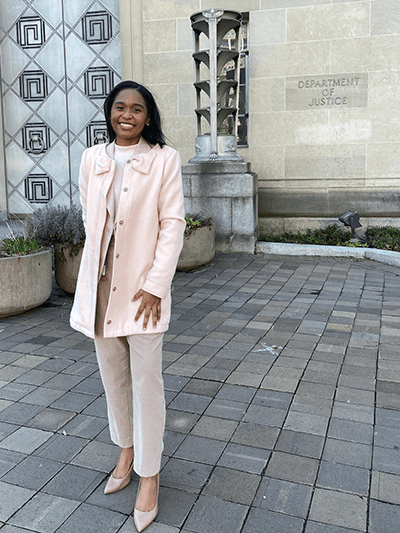 Toomer smiles outside the U.S. Department of Justice in Washington, D.C.