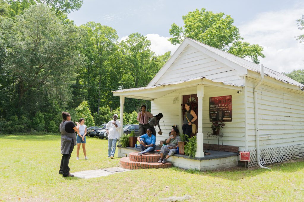 Historic Preservation field school students listen to Jobie Hill talk about the architectural history of praise houses at Moving Star Hall.