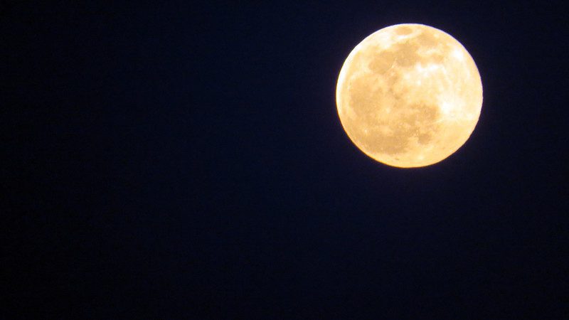a photo of a full moon in a black sky