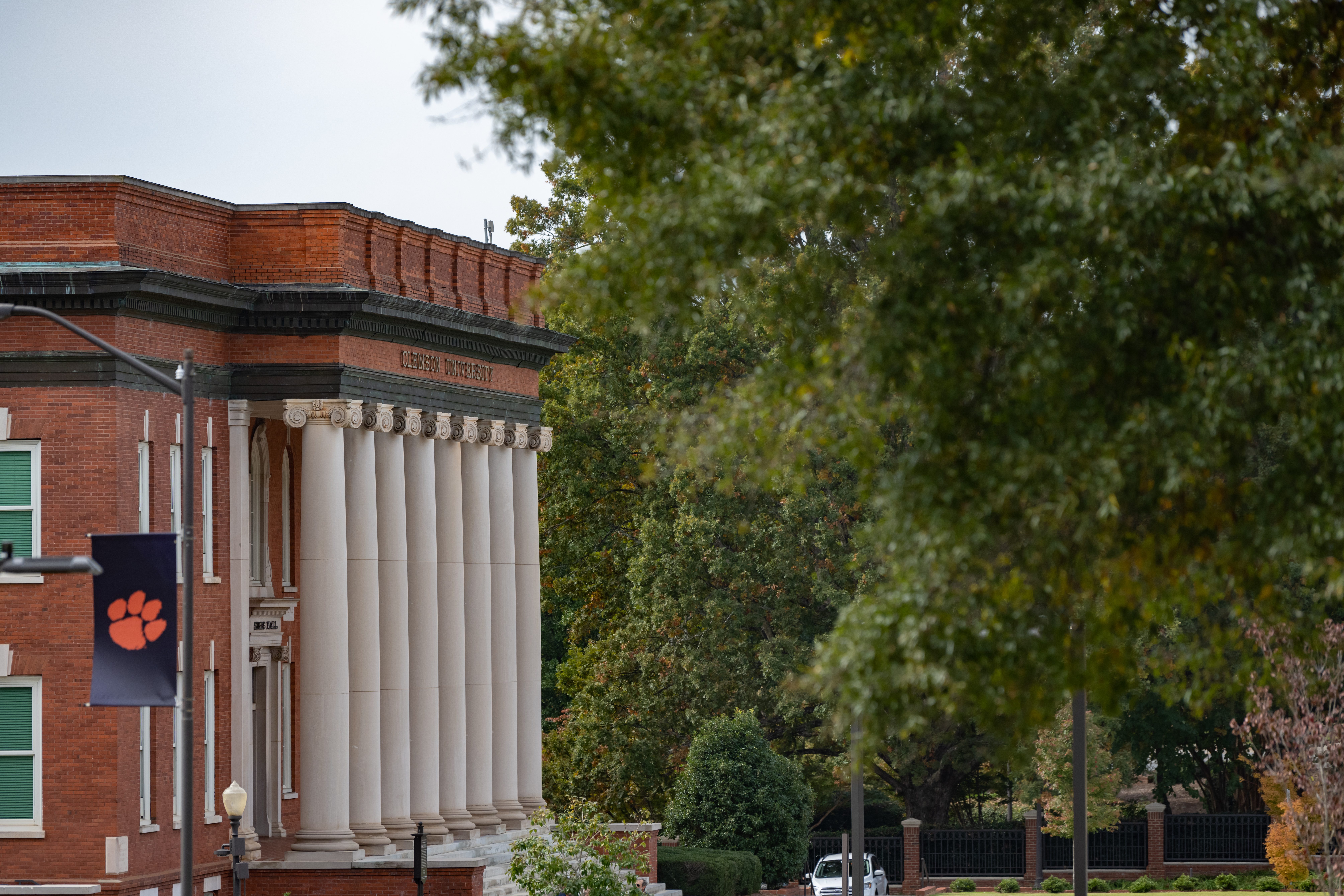 Sikes Hall with a large tree in the foreground.