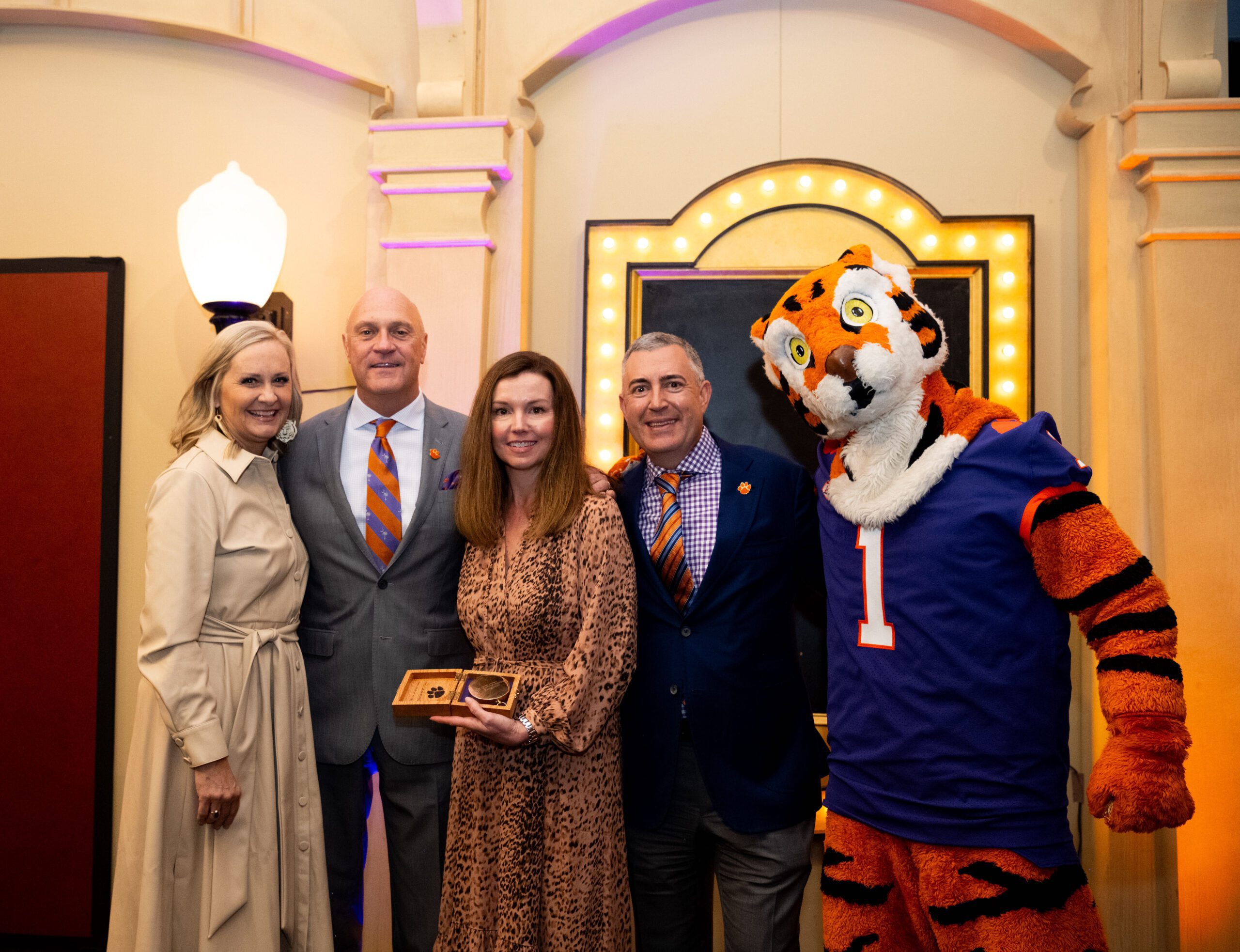 Group standing on stage with Tiger mascot