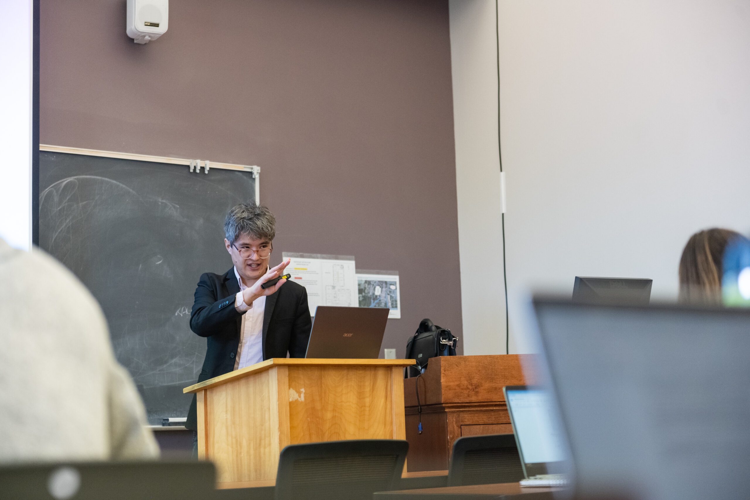 Quinn Hiroshi Gibson lectures inside a Hardin Hall classroom.