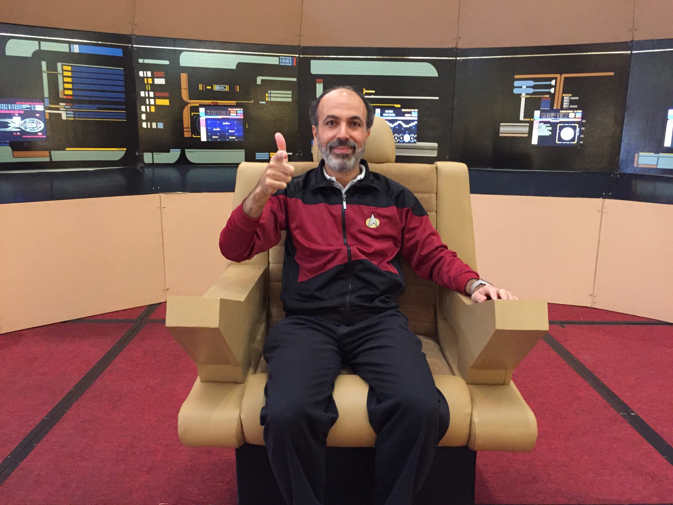 Mohamed Noor, a professor at Duke University, sits in the Enterprise seat while dressed in Star Trek clothes.