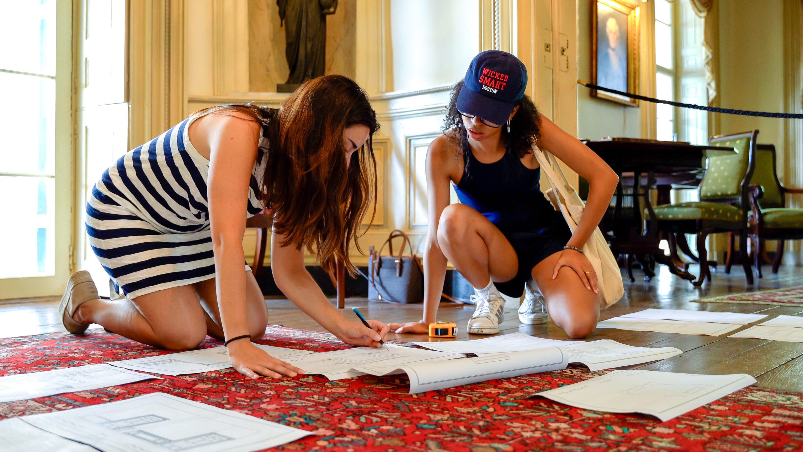 Historic Preservation student and teacher looking at floor plans.