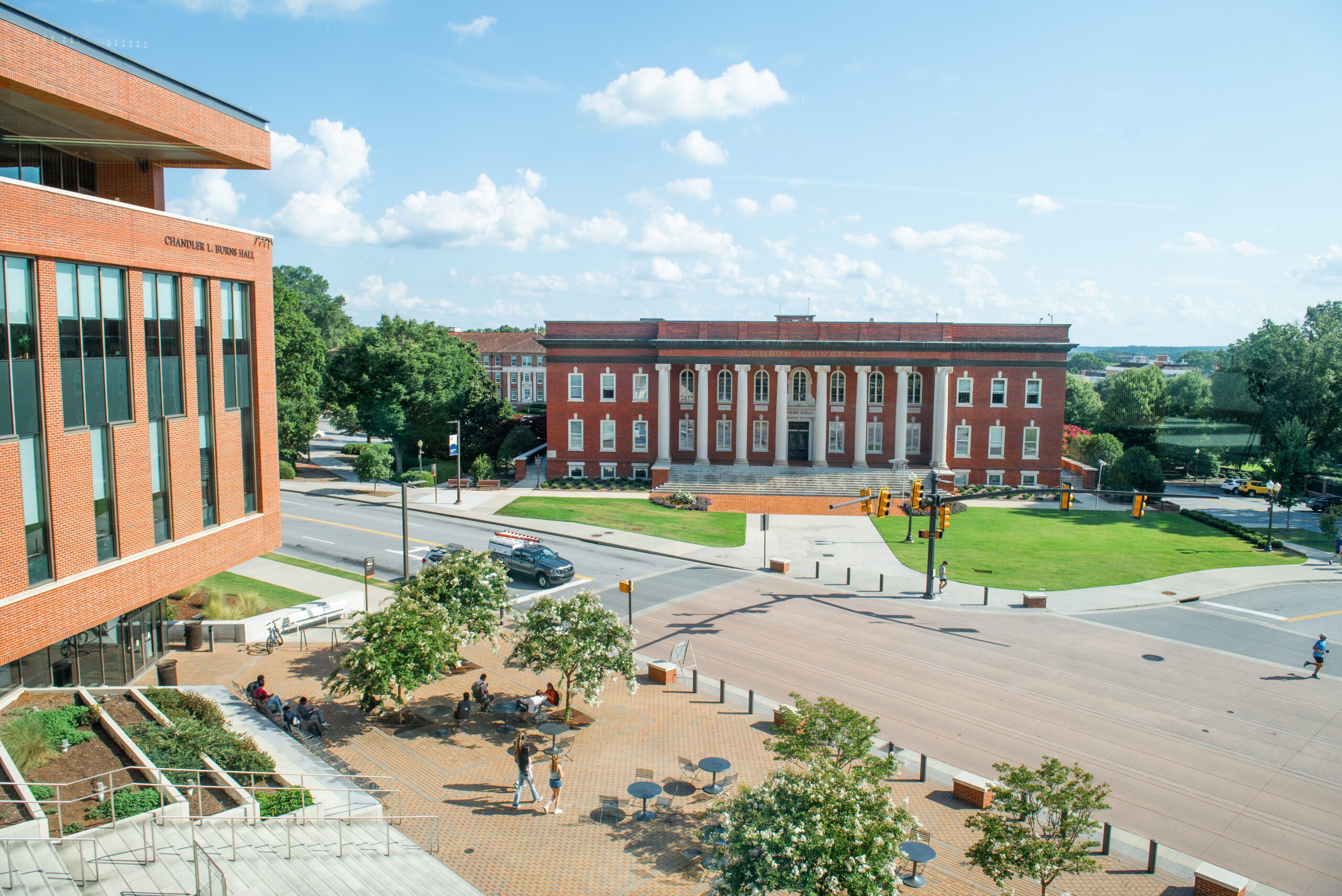 A landscape image of Sikes Hall from across the street, with Chandler L. Burns Hall in the foreground on the left side.