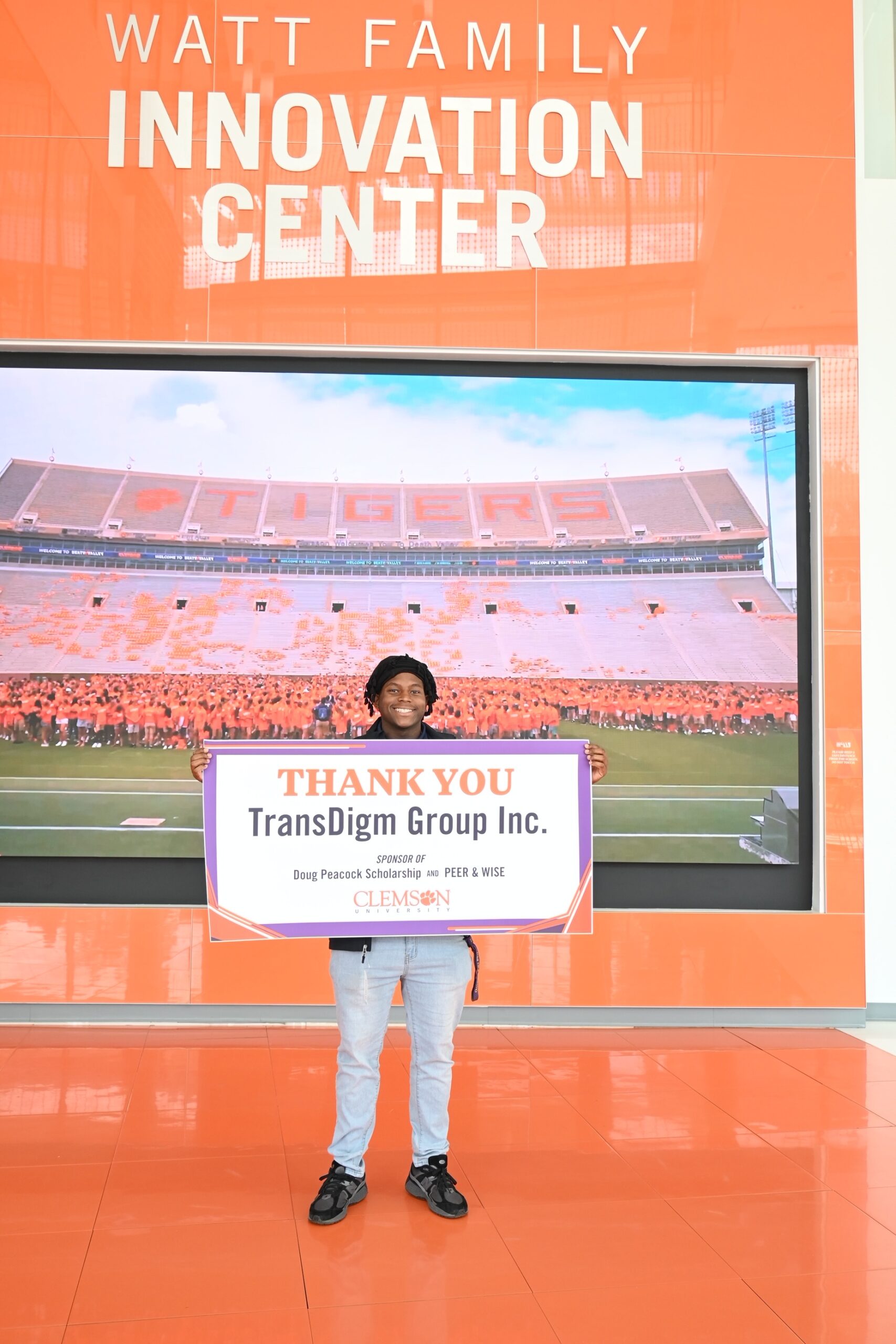 Student with thank you sign for TransDigm Group Inc.