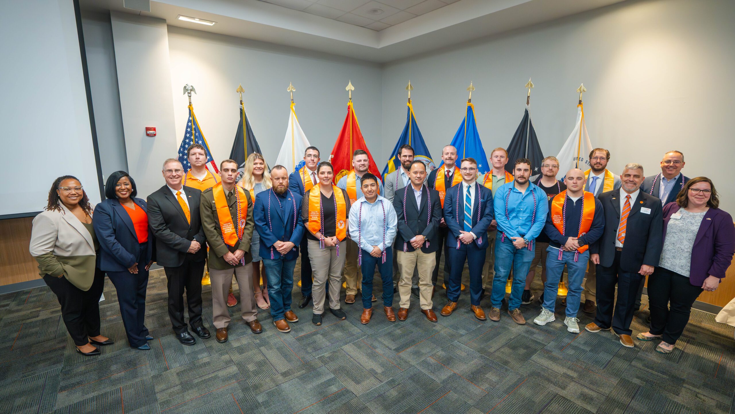 December 2024 service member and veteran graduates with members of the University administration