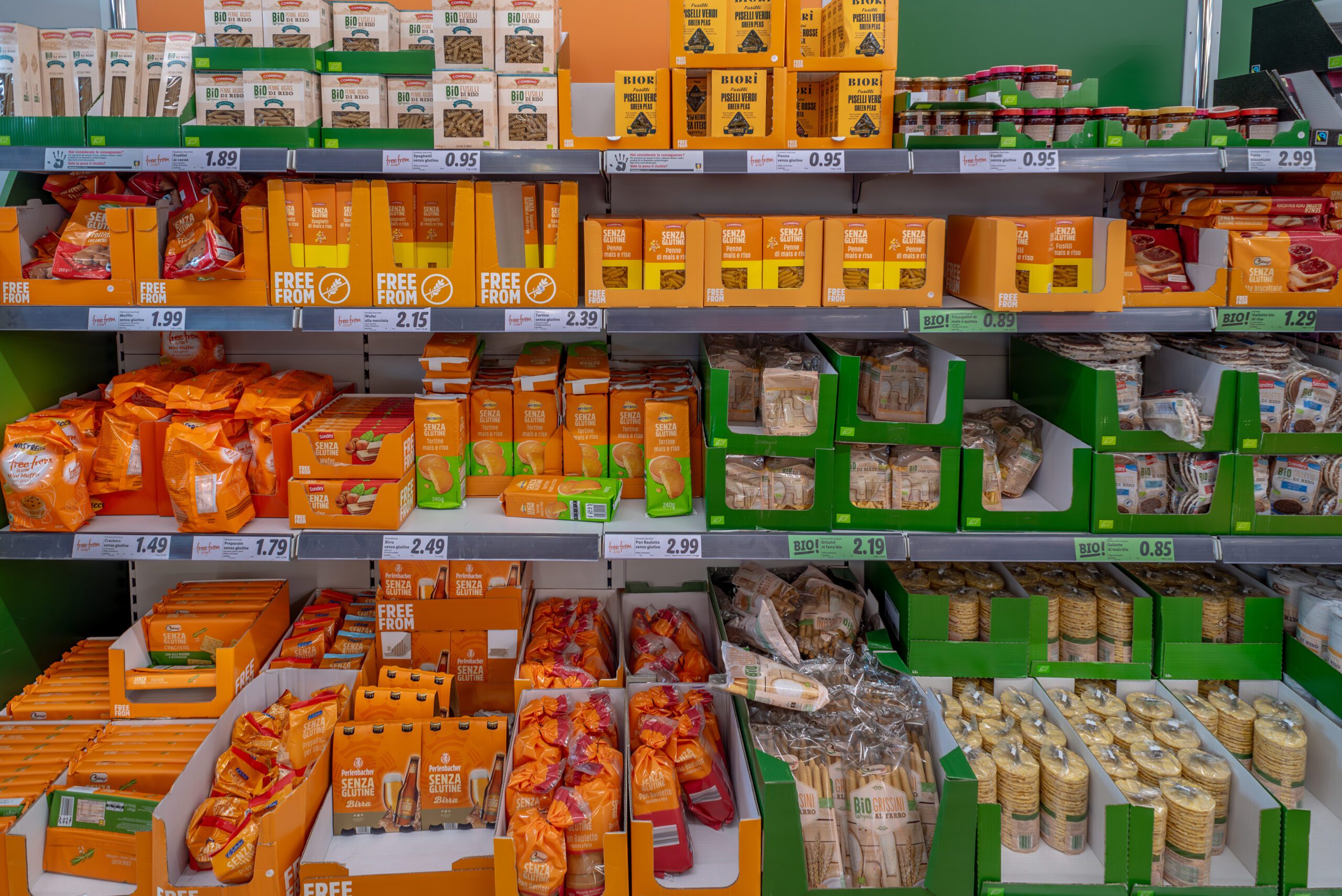 A grocery store shelf is filled with gluten-free food items.