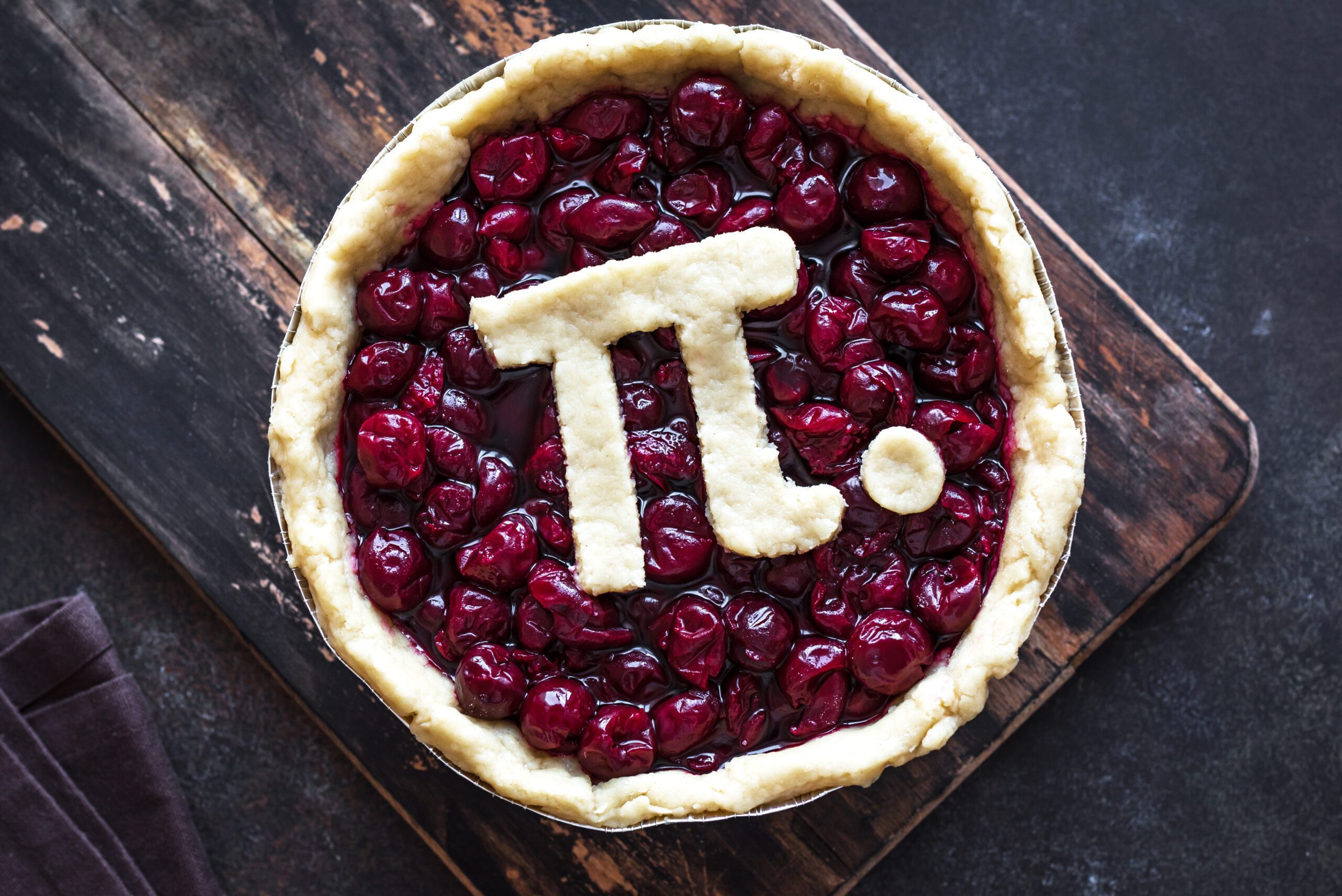 A cherry pie with a symbol of pi on top.