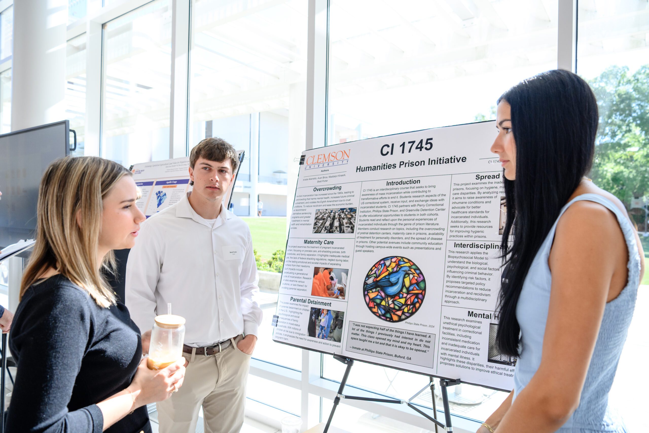 Brett Porter and Maddalyn Knaack display their Creative Inquiry project poster in Watt Family Innovation Center on April 11, 2025