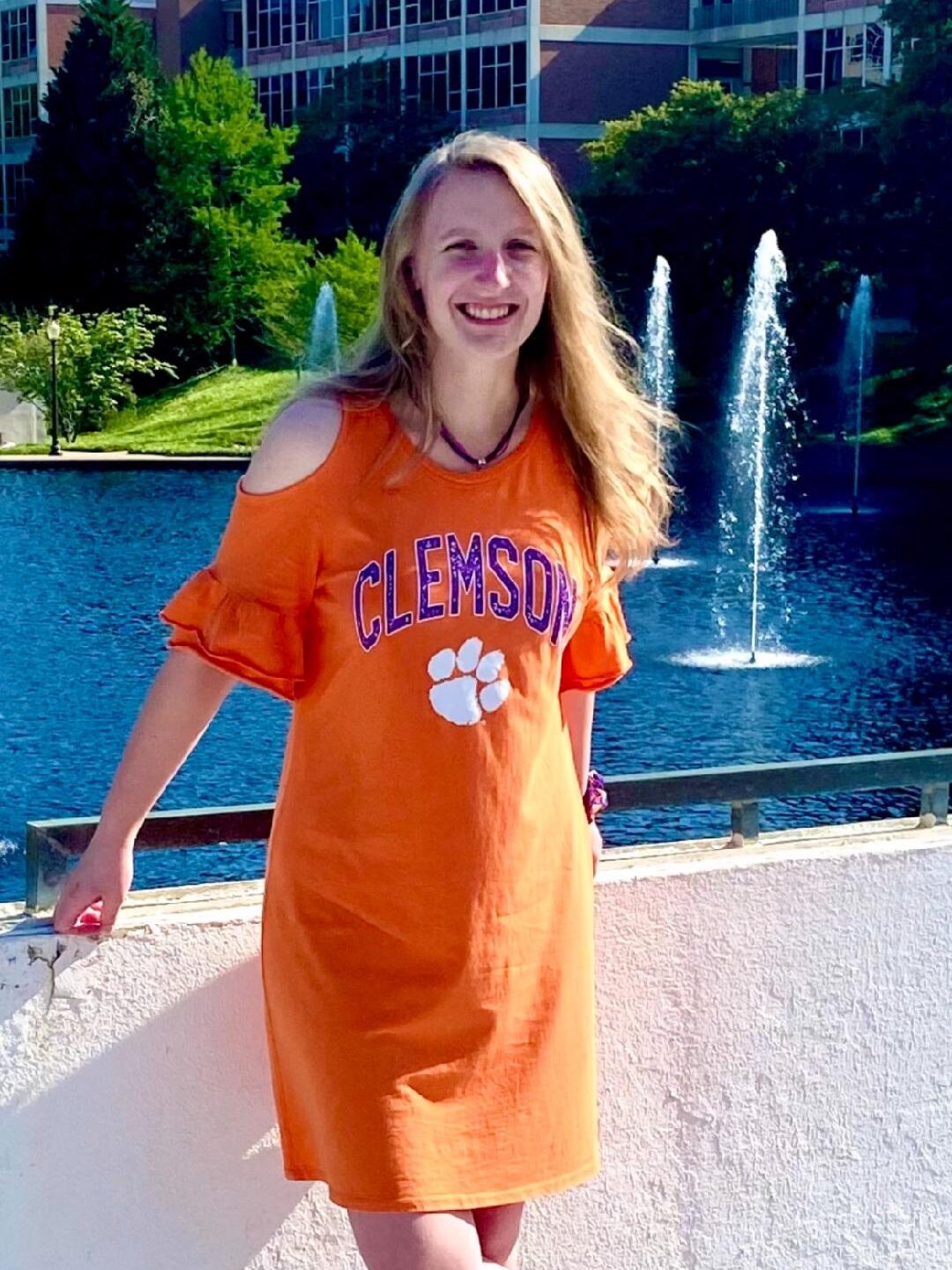 A woman standing beside a pond, she is a Brooks scholar