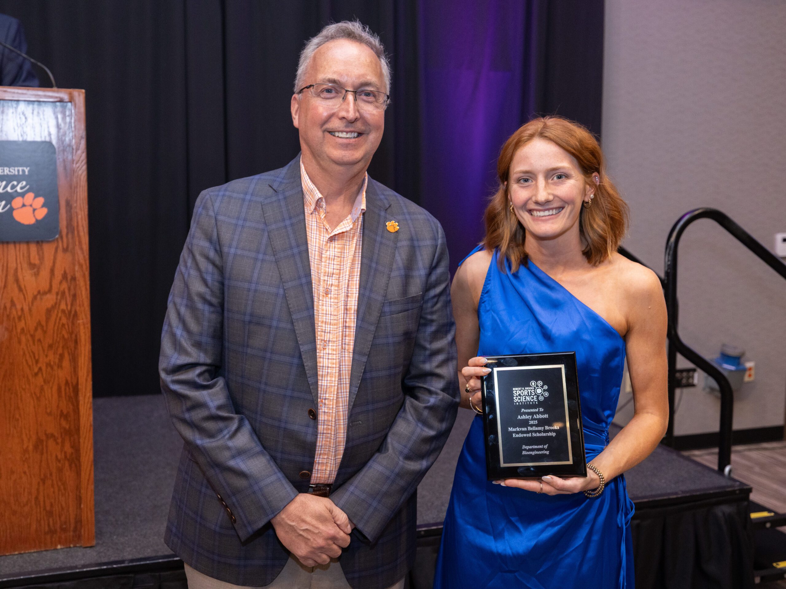 A man and a woman posing with award