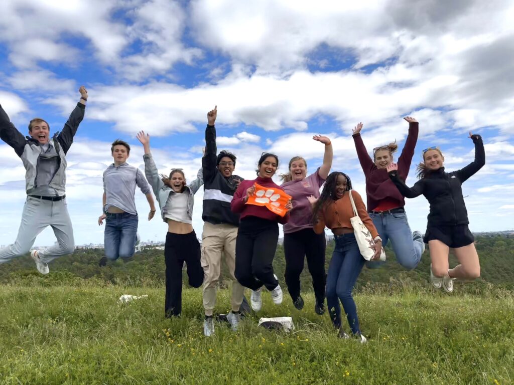 Briggs Murray and his National Scholars Program cohort jumping in the air on one of their learning abroad experiences last summer.