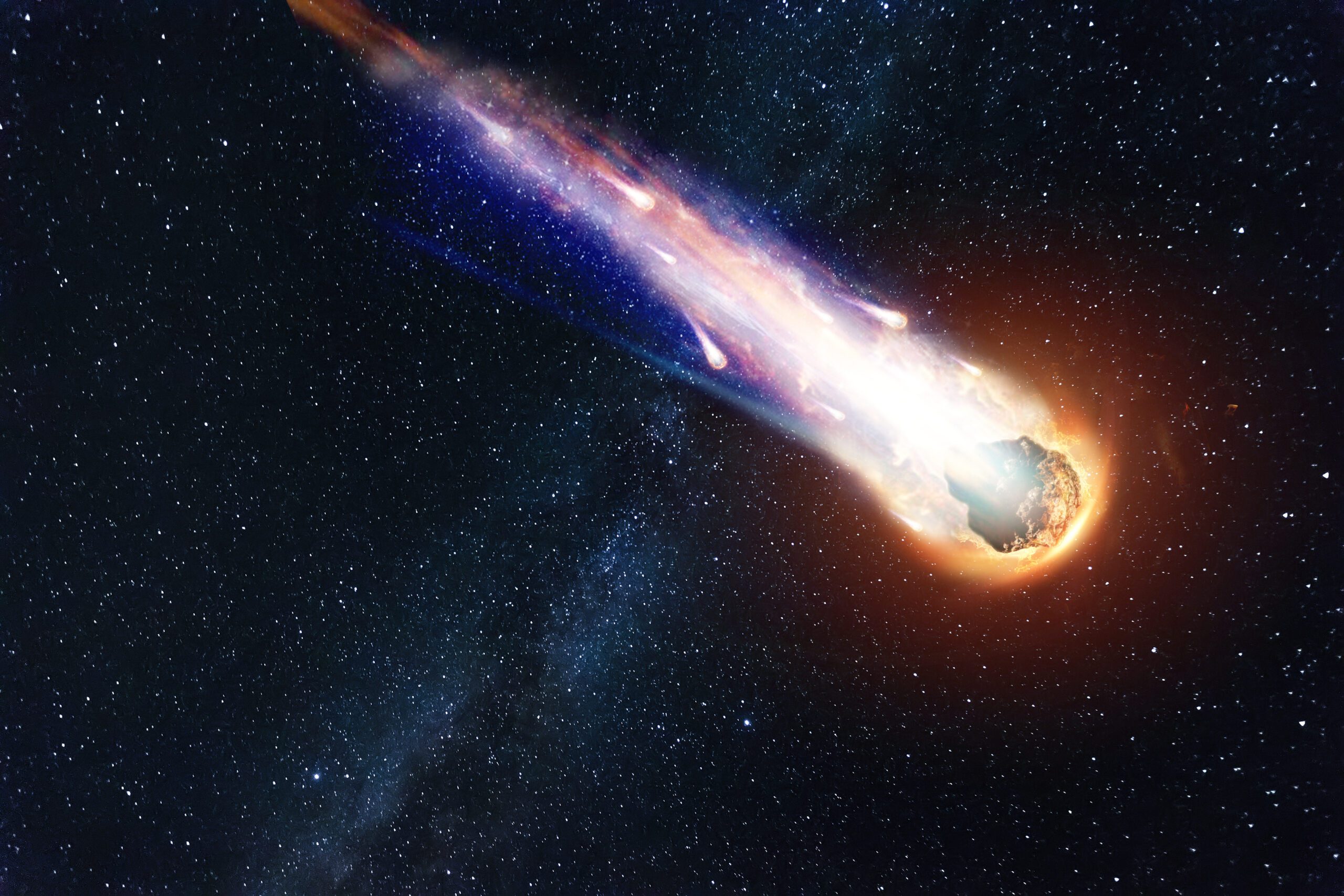 An artist's rendering of an asteroid falling to the ground against a starry sky