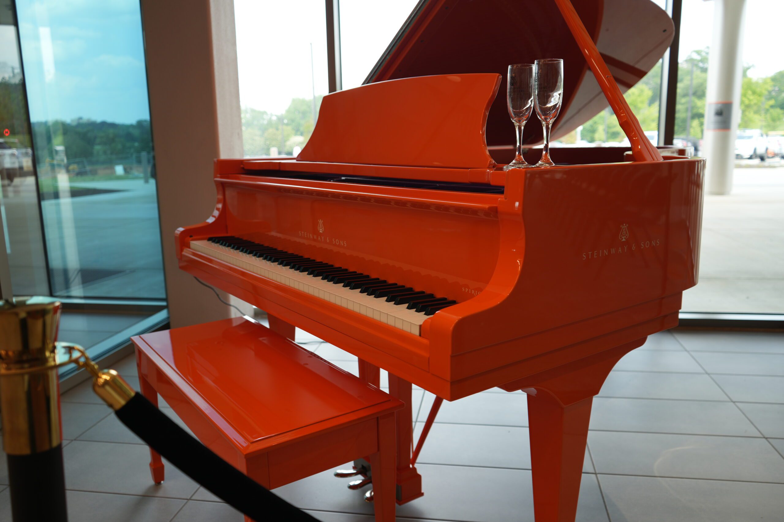 An orange Steinway and Sons Piano in the Nieri Family Alumni and Visitors Center at Clemson University