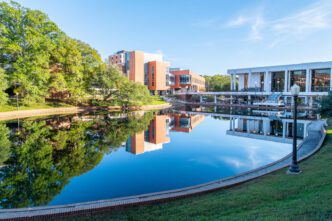 Daniel Hall, home of the College of Arts and Humanities, is reflected in the reflection pool on Clemson campus