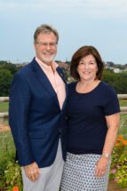 Brad and Lyle Smith stand with Clemson's campus behind them on the roof top terrace of the Nieri Family Alumni and Visitors Center.