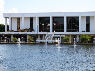 A picture of Cooper Library with the reflection pond in the foreground