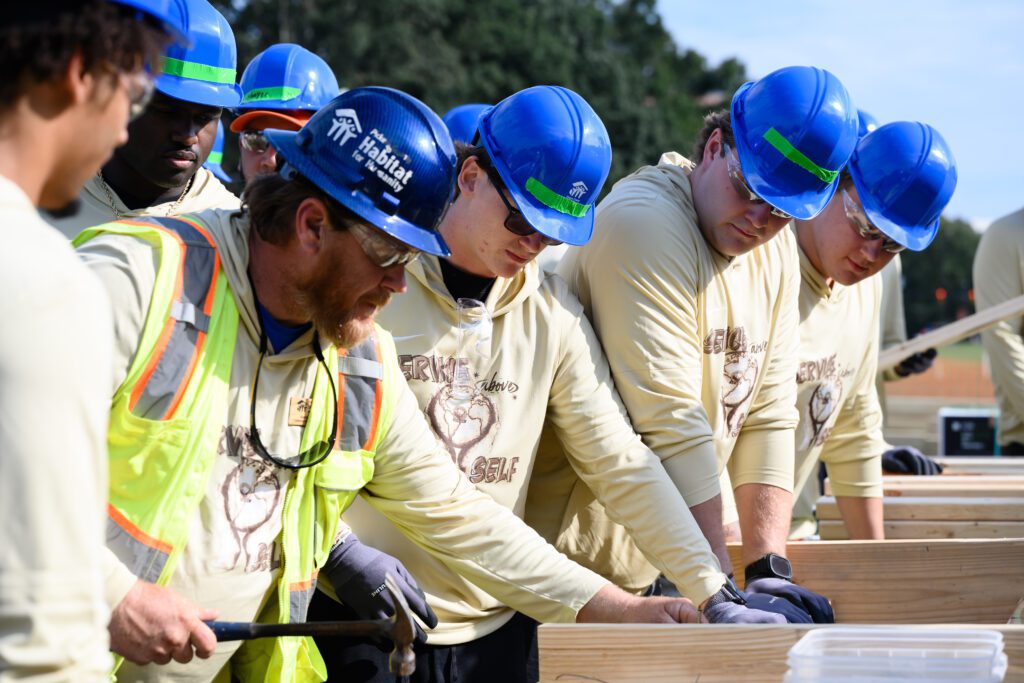 Members of the Clemson football team at the Habitat for Humanity house build on Bowman Field