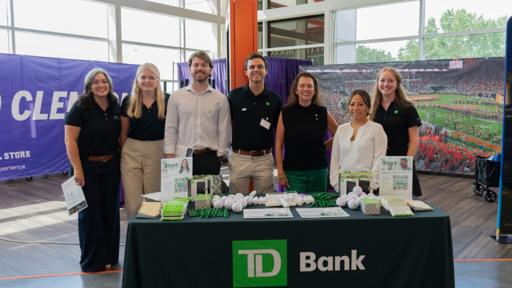 Christian Afonso, who helped employee learning at TD Bank, poses with TD Bank staff.